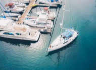 white_boat_leaving_the_marina_docks_sailing_on_the_water