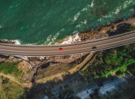 1726834767_19_narrow-curvy-road-with-cars-alongside-green-mountains