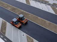 aerial_view_orange_vibratory_asphalt_roller_compactor_new_pavement